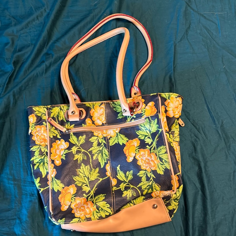 Tignanello pebbled leather purse in floral design.  Very good condition.